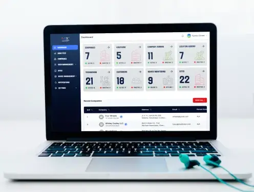Laptop showing septic system monitoring software dashboard
