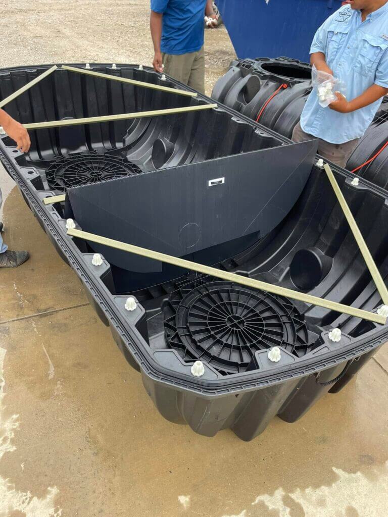 Large wastewater treatment tank component being assembled outdoors